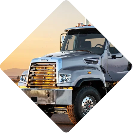 The image presents the Freightliner 114SD, which is specially equipped to run on natural gas. Utilizing natural gas as an alternative fuel offers several benefits, such as reduced emissions and a lower total cost of ownership compared to traditional diesel-powered vehicles. The design of the 114SD remains robust and capable, indicating its readiness for heavy-duty applications while being environmentally conscious. The choice of natural gas signifies Freightliner's commitment to sustainable transport solutions without compromising on performance or reliability.