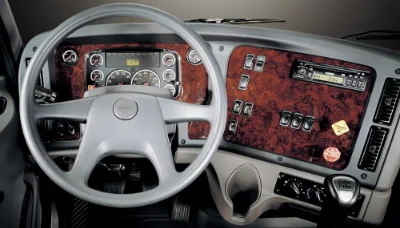 108sd Natural Gas truck interior showcasing detailed dashboard with wood grain finish and steering wheel