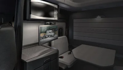 Interior view of Freightliner Cascadia cabin showcasing the sleeping area, TV, and branded wall design