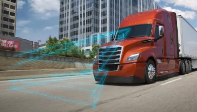 Red Freightliner truck in motion with holographic safety and performance indicators displayed around it