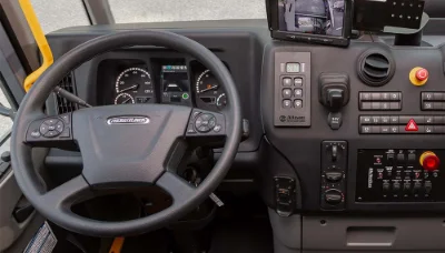 Close-up of Freightliner econicSD truck's steering wheel and dashboard controls