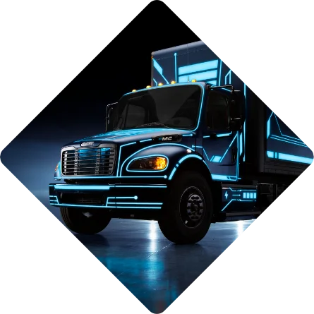 Freightliner eM2 electric truck with blue neon highlights in a dark studio setting