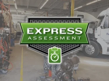 Express Assessment logo overlaying an image of a bustling service shop, depicting the fast and efficient service provided by Francis Canada Truck Centre.