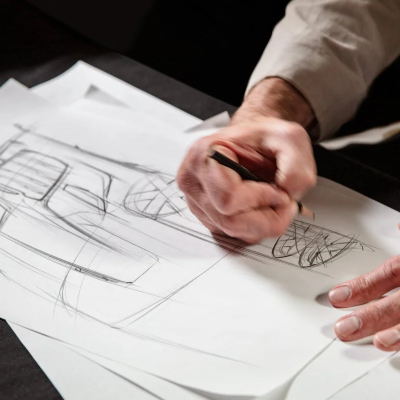 Artist sketching the initial design of the SuperTruck II, representing the collaboration between design, engineering, and global powertrain teams to create an aerodynamic and efficient truck.