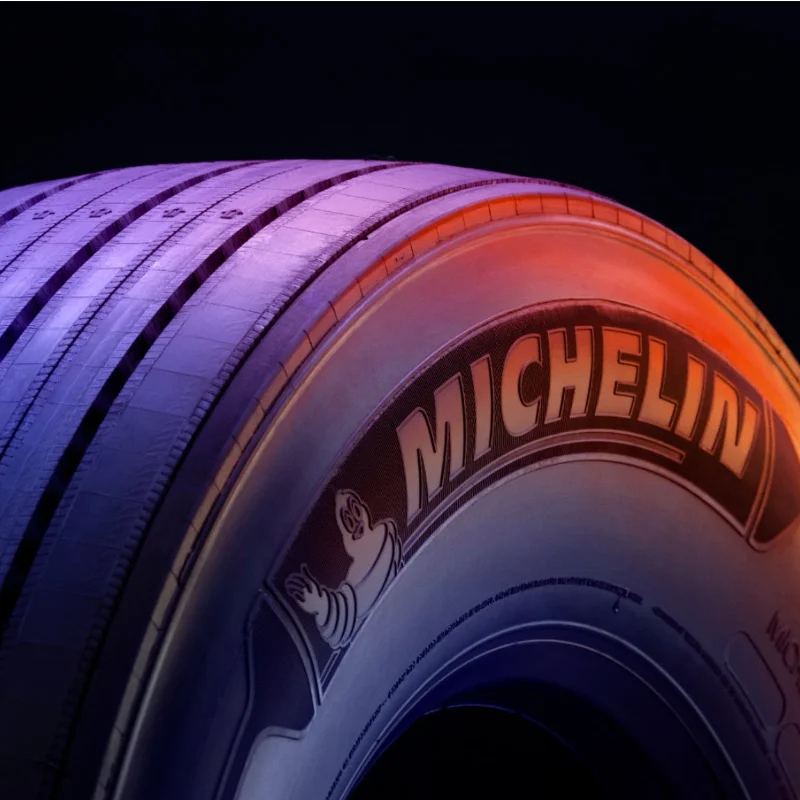 Michelin tire showcasing innovative tread design and compound, symbolizing the partnership for enhanced fuel efficiency and reduced emissions.