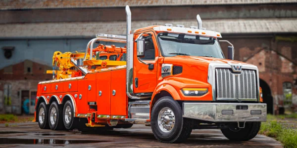 Western Star 49x orange truck with towing equipment in industrial setting, Ottawa Ontario dealership